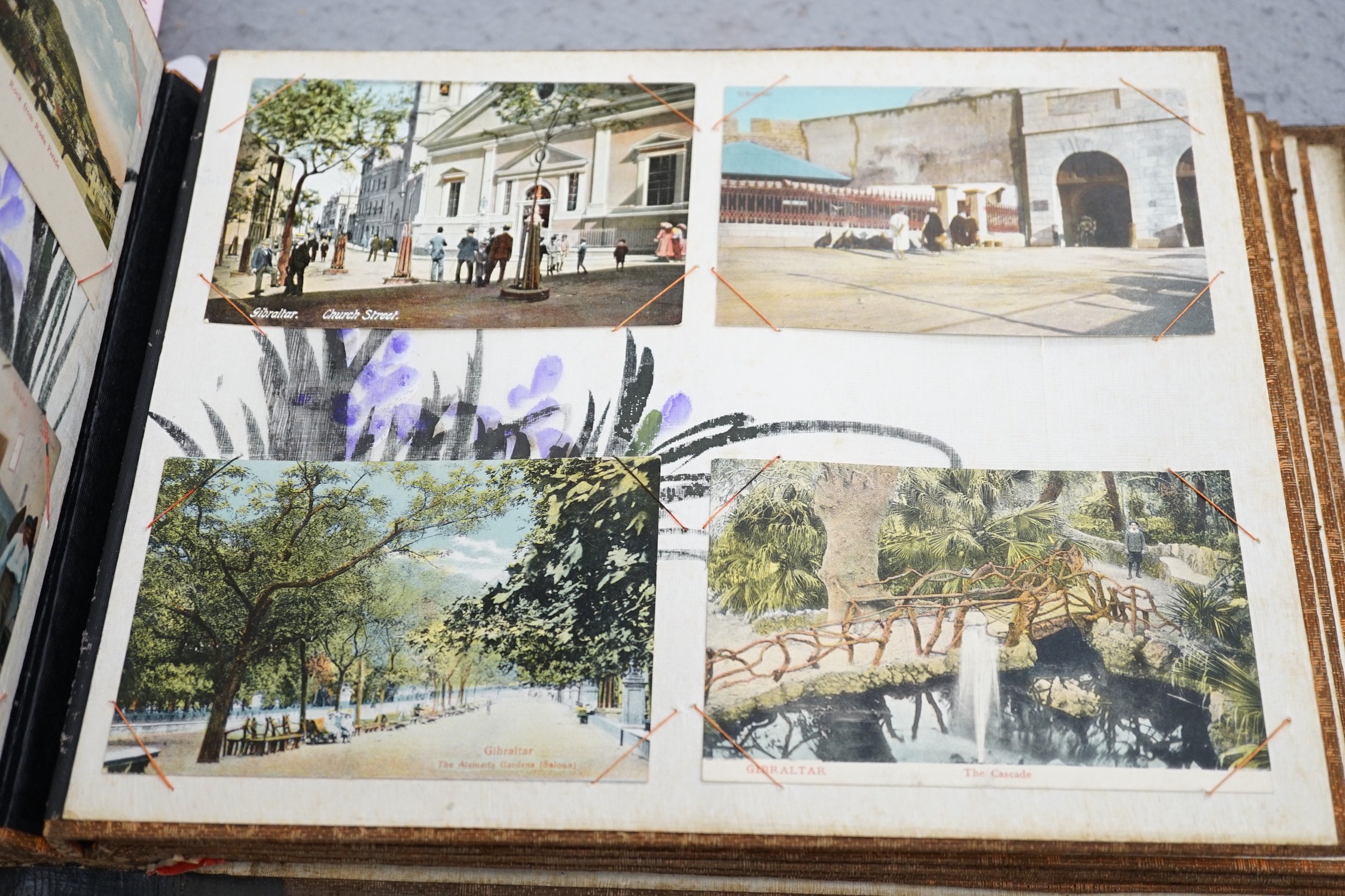 An early 20th century inlaid postcard album and contents